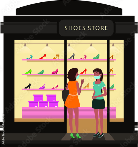 A woman talking to the sales woman at shoes store