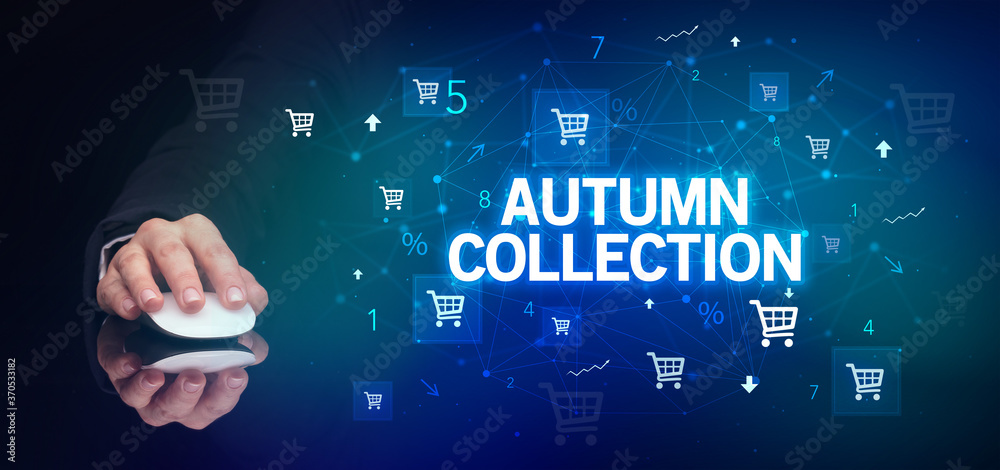 hand holding wireless peripheral with AUTUMN COLLECTION inscription, online shopping concept hand holding wireless peripheral with AUTUMN COLLECTION inscription, online shopping concept