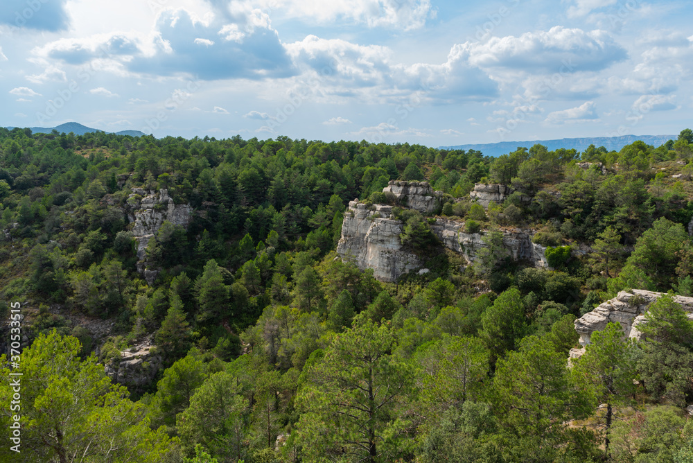 View of a mountain landscape in the Prades area in Catalonia with green and blue tones of the sky and clouds