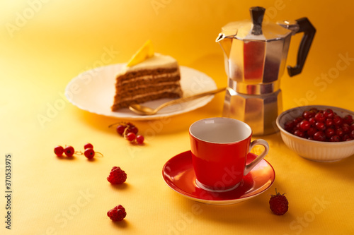 Red cup of coffee and a geyser coffee on a yellow background. With copy space.