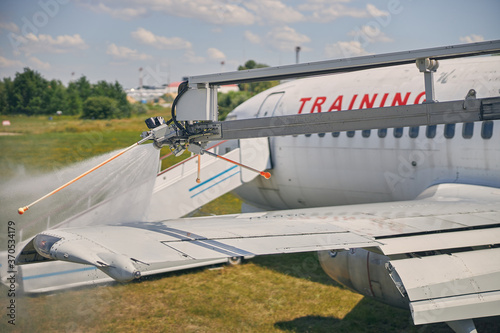 Close up of special unit washing airplane wing