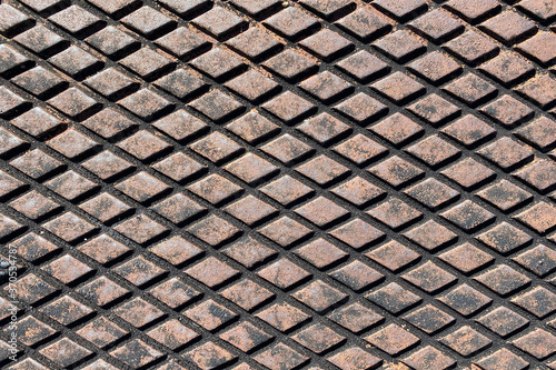 rusty retro wide angle view diamond plate storm drain cover