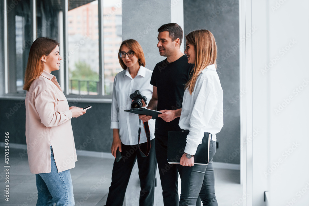 Group of business people in formal clothes that standing indoors Group of business people in formal clothes that standing indoors