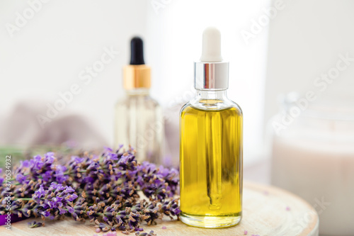 Skincare oil, lavender serum, lavender essential oil. Set lavender bath cosmetics products in bottles with fresh lavender flowers. Natural spa products. Aromatherapy hair treatment