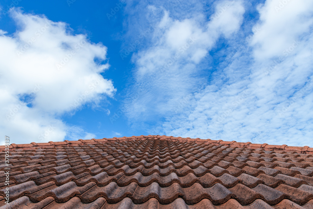 Close up of brown clay roof tiles. Red old dirty roof. Old roof tiles. Construction equipment build a house.