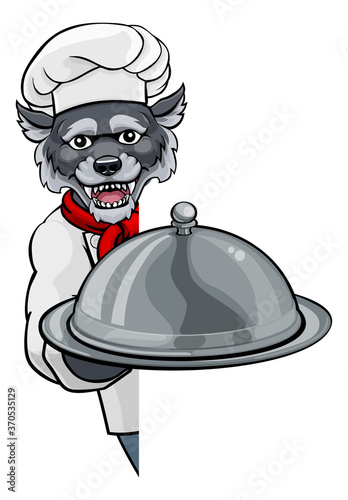 A wolf chef mascot cartoon character holding a silver platter cloche dome of food peeking round a sign