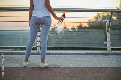 Sporty lady holding a bottle of water
