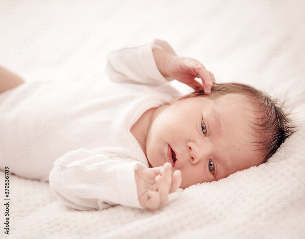 Cute newborn baby girl lying in the bed Cute newborn baby girl lying in the bed