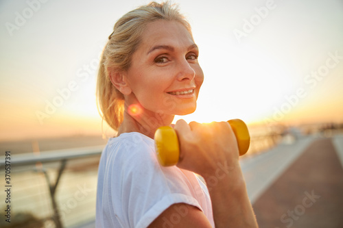 Принти на полотні Sporty lady standing on a bridge during the training