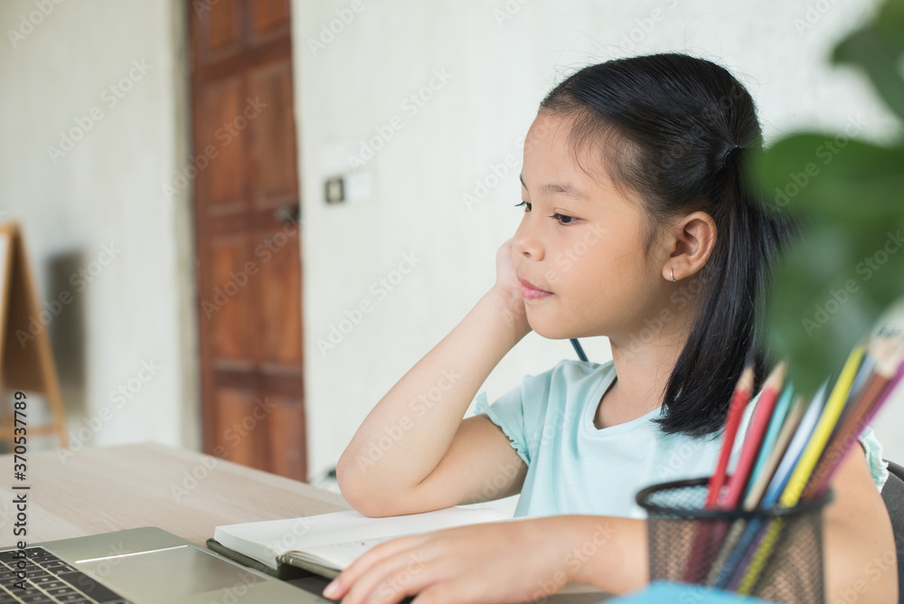 pretty stylish schoolgirl studying homework during online lesson at home, social distance during quarantine, self-isolation, online education concept, home school, study online video call teacher. pretty stylish schoolgirl studying homework during online lesson at home, social distance during quarantine, self-isolation, online education concept, home school, study online video call teacher.