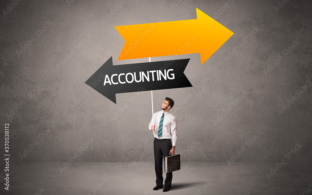 Obraz premium Young business person in casual holding road sign with ACCOUNTING inscription, business direction concept