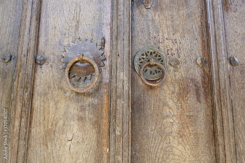 Detail of an old wooden door with specific handles with wrought iron ornaments from Zheravna, Bulgaria