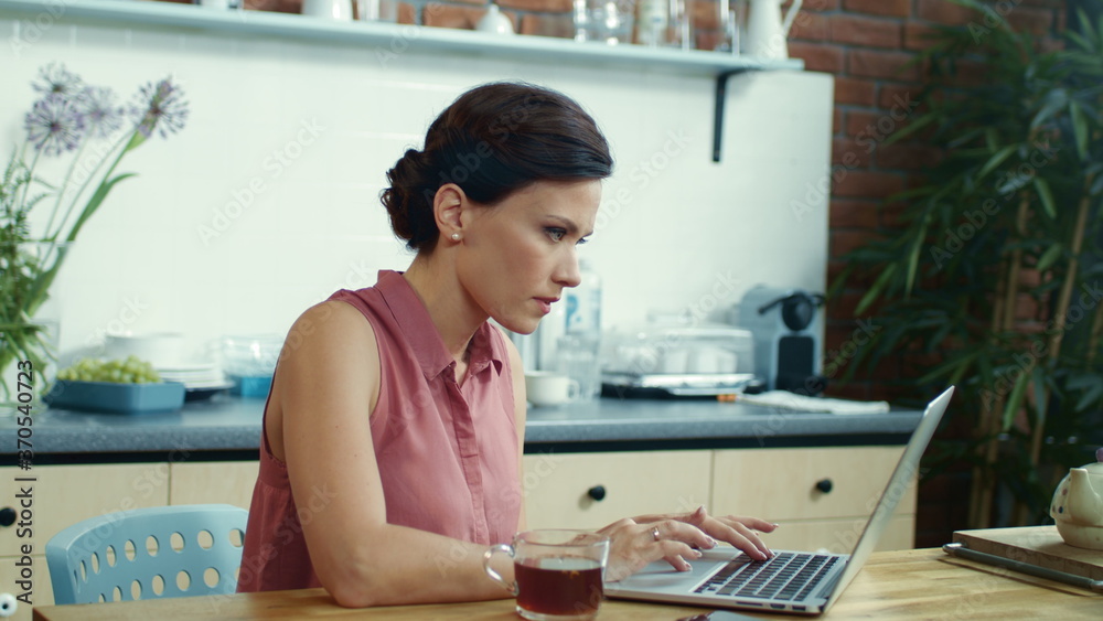 Business woman working on laptop in home office. Female freelancer getting idea. Business woman working on laptop in home office. Female freelancer getting idea.
