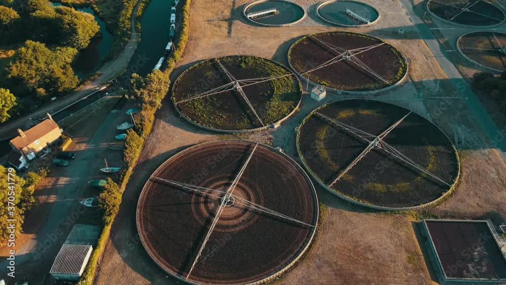 Wide aerial of water purification circle, clean drinking water. Ecosystem of filtration, fresh water and water management. Sewage treatment plant in the sun