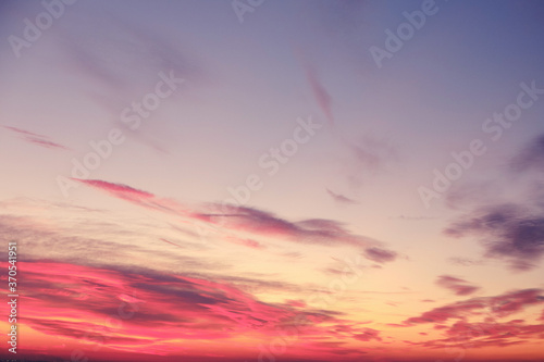 Fototapeta Naklejka Na Ścianę i Meble -  Orange sunset and clouds in the blue sky over the evening city, background
