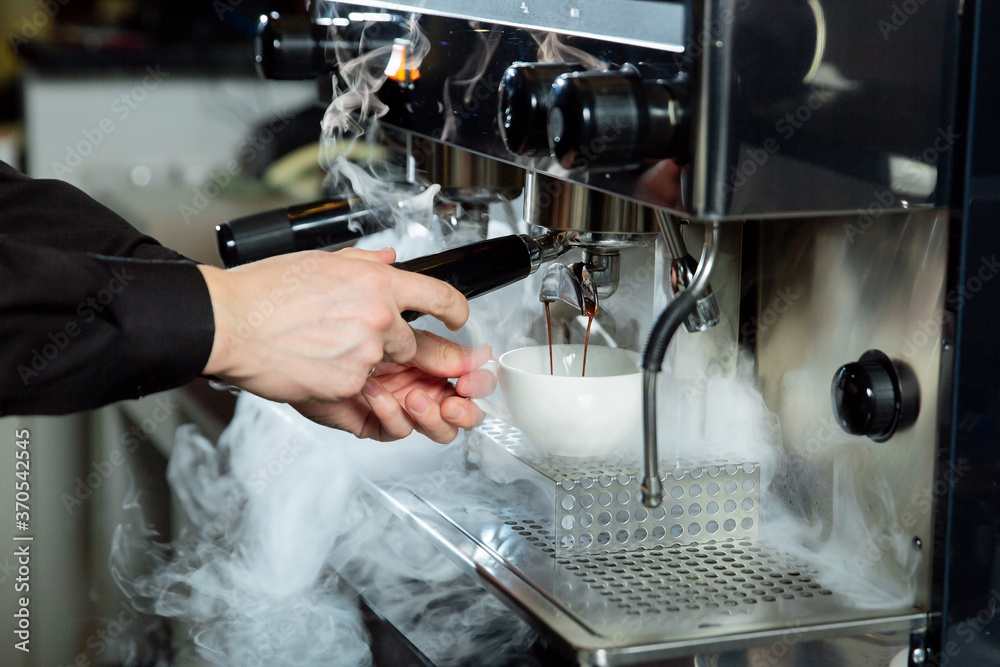 coffee making process; espresso cup and coffee machine; bartender make morning espresso