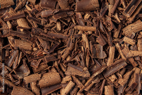 Dark chocolate shavings textured background. Close-up chocolate chips. Flat lay. Copy space. © Grigoriy