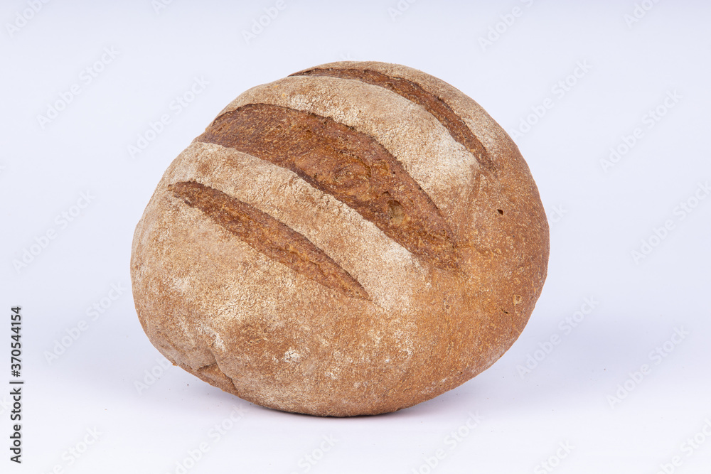 a loaf of fresh crunchy rye bread on a white background
