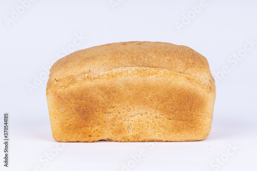 a loaf of fresh crunchy wheat bread on a white background