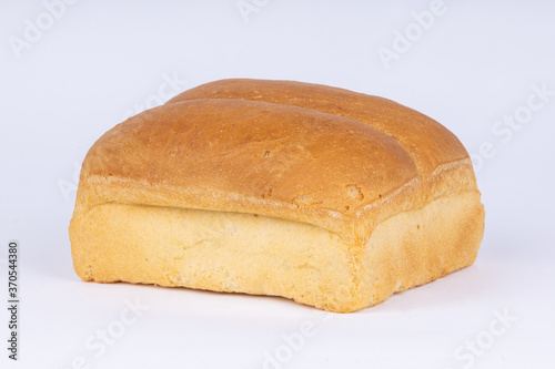 double loaf of fresh wheat bread on a white background