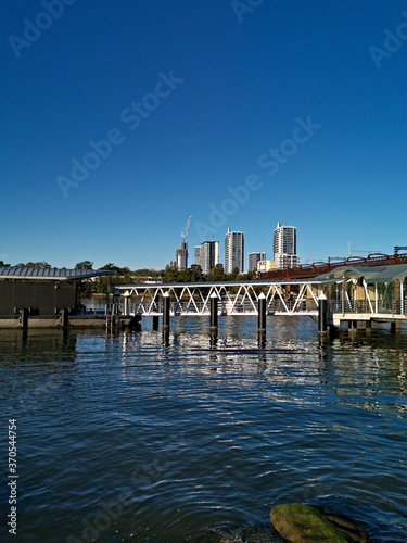Beautiful view of a wharf along a river on a sunny day with deep blue sky, Parramatta river, Meadowbank, Sydney, New South Wales, Australia
