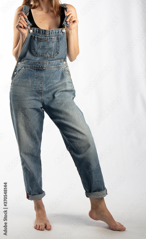 young girl in denim overalls, studio shooting