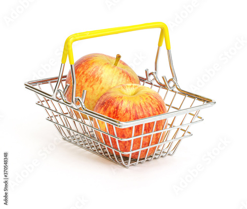 a small shopping basket with fruits, apples, on a white background. Healthy food, vegetarian food, vegetables, shopping at the supermarket.