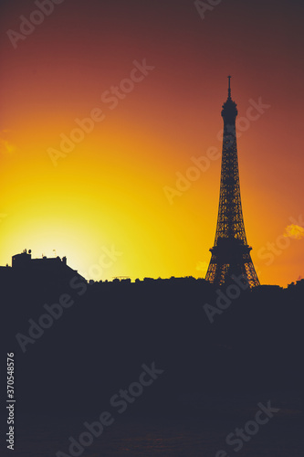 Cityscape of Paris, France and famous landmark Eiffel tower in silhouette just before sunset.