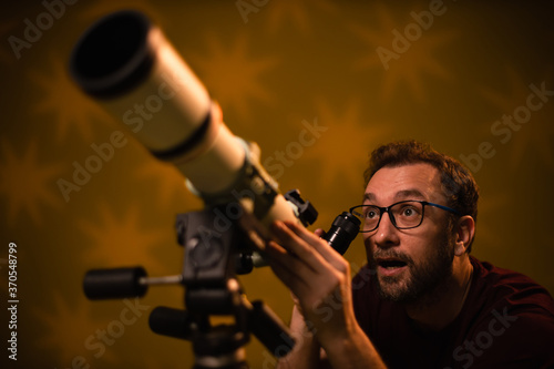 Amateur astronomer looking at the stars with a telescope. Astronomy and astrology concept.