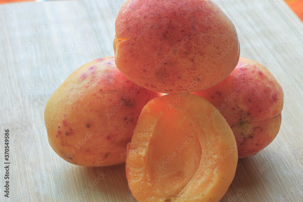 large ripe apricots close-up on a wooden board large ripe apricots close-up on a wooden board