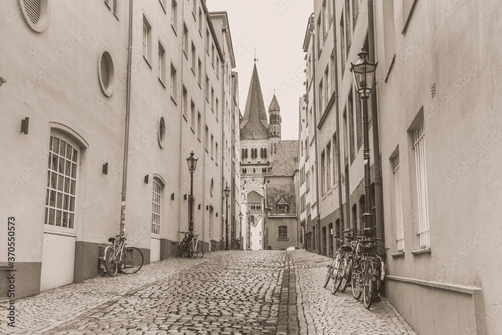 Cityscape, in black-and-white color - view of a medieval street near the Great Saint Martin Church in Cologne, North Rhine-Westphalia, Germany