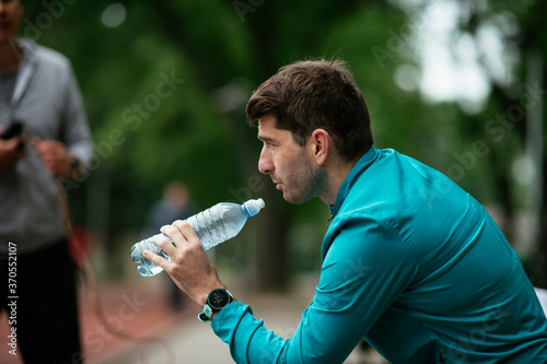 Thirsty athlete. Man having water after a workout...