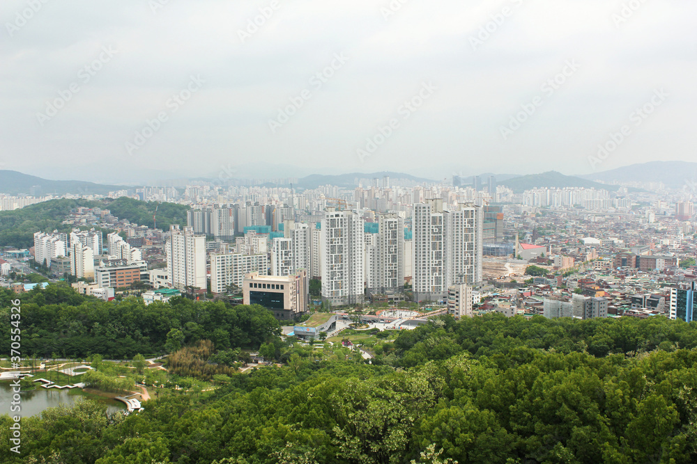 SEOUL, SOUTH KOREA ;  Aerial view of Seoul, houses and forest view.