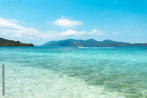 Clear water on the island,Bright blue sea and wooden boat The tourism