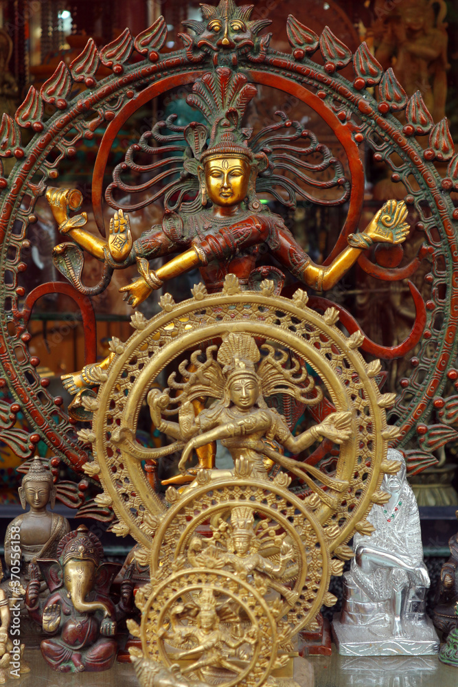 A lot of bronze dancers of Shiva of different sizes in the souvenir shop.