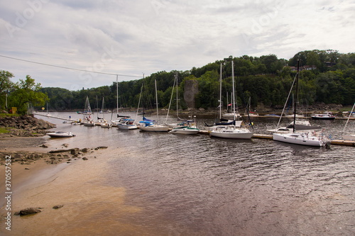 Series of boats anchored at low tide in the mouth of the Chaudière River near the St. Lawrence River, Lévis, Quebec, Canada