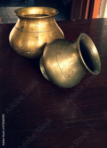 Brass made pots with dark background.