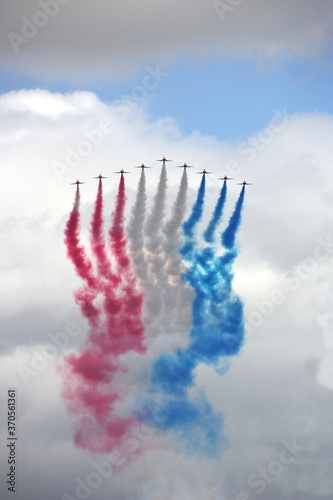 Flying jets with red white and blue smoke trails