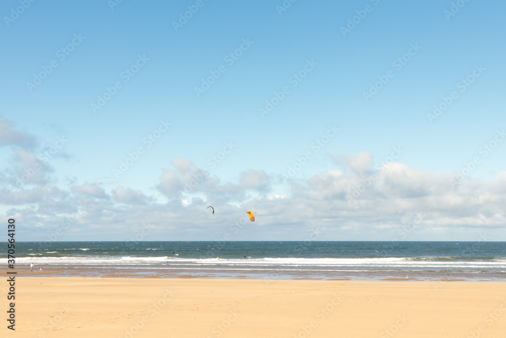South Shields beach (South Promenade) on summer day with kite boarders at sea