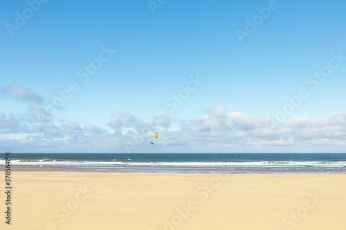 South Shields beach (South Promenade) on summer day with kite boarders at sea
