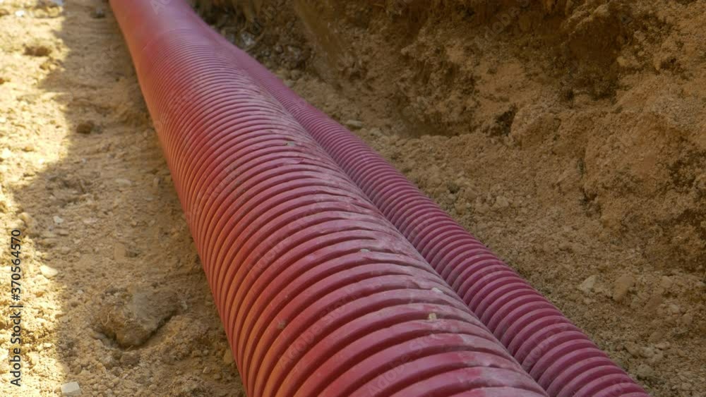 CLOSE UP: Detailed shot of corrugated plastic telecommunication tubing ...