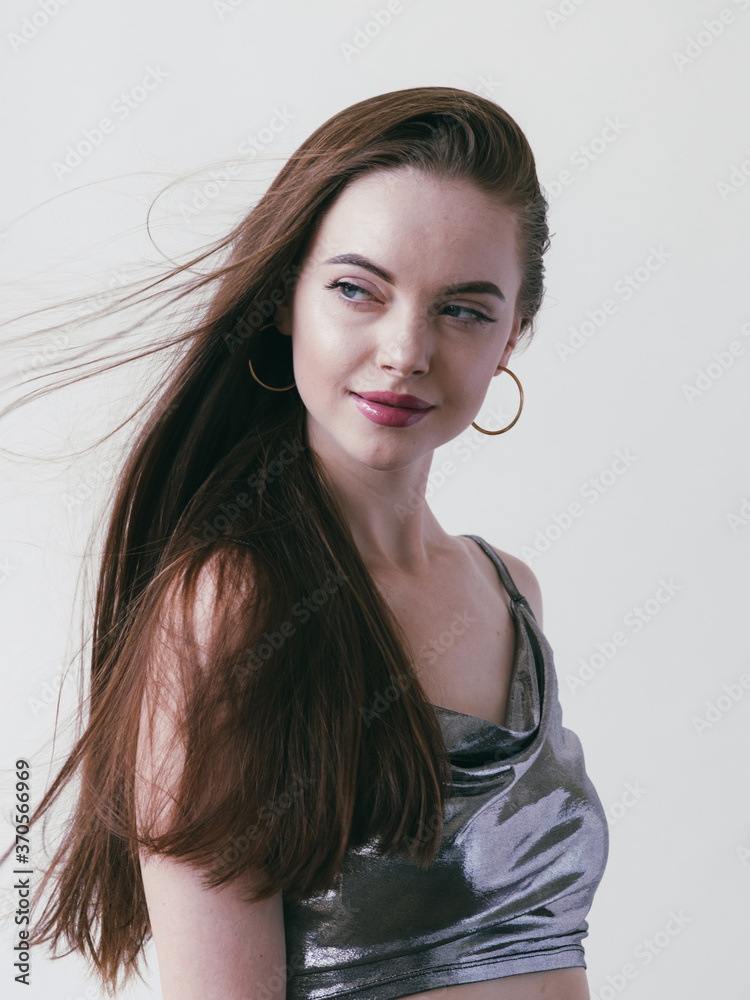 Fototapeta premium Beautiful brunette woman girl with long hair smooth and beauty in silver wear