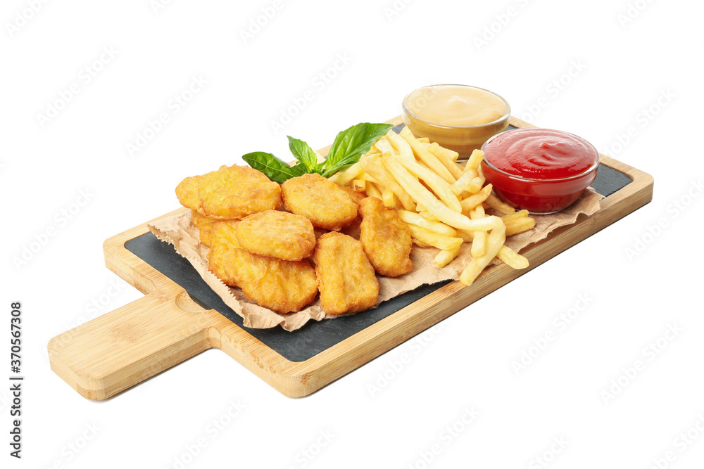 Naklejka premium Board with chicken nuggets, potato and sauces isolated on white background