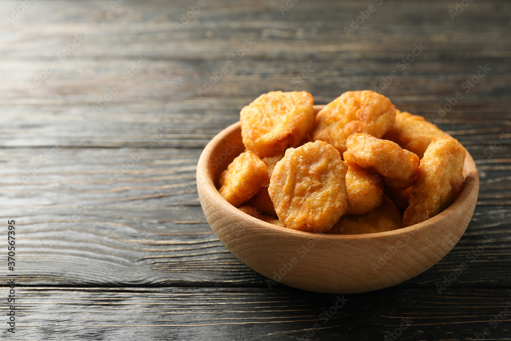 Bowl with fried chicken nuggets on wooden background Bowl with fried chicken nuggets on wooden background