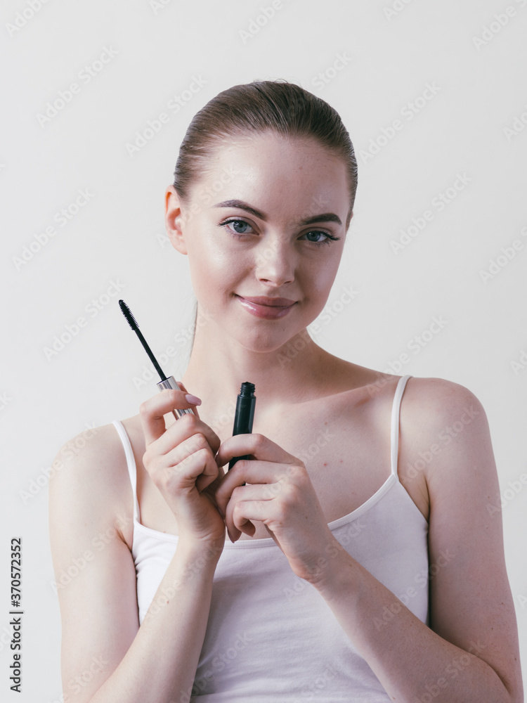 Fototapeta premium Mascara woman portrait, beautiful brunette model applying brush mascars eyes lashes