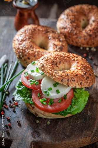 Tasty bagel with tomatoes, mozzarella and lettuce