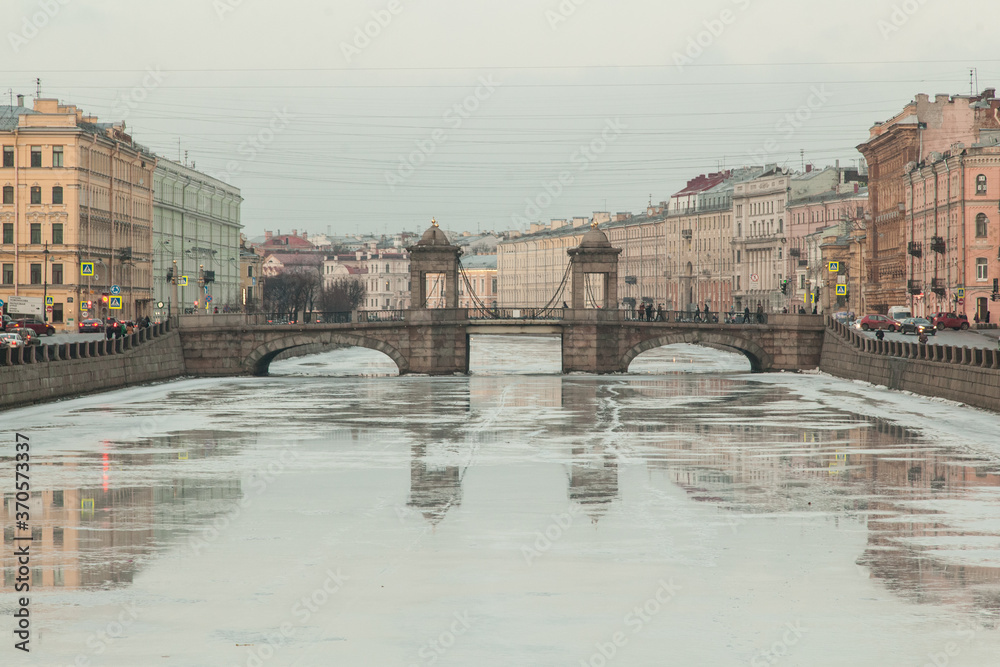 Lomonosov's bridge reflected in freezing Fontanka river