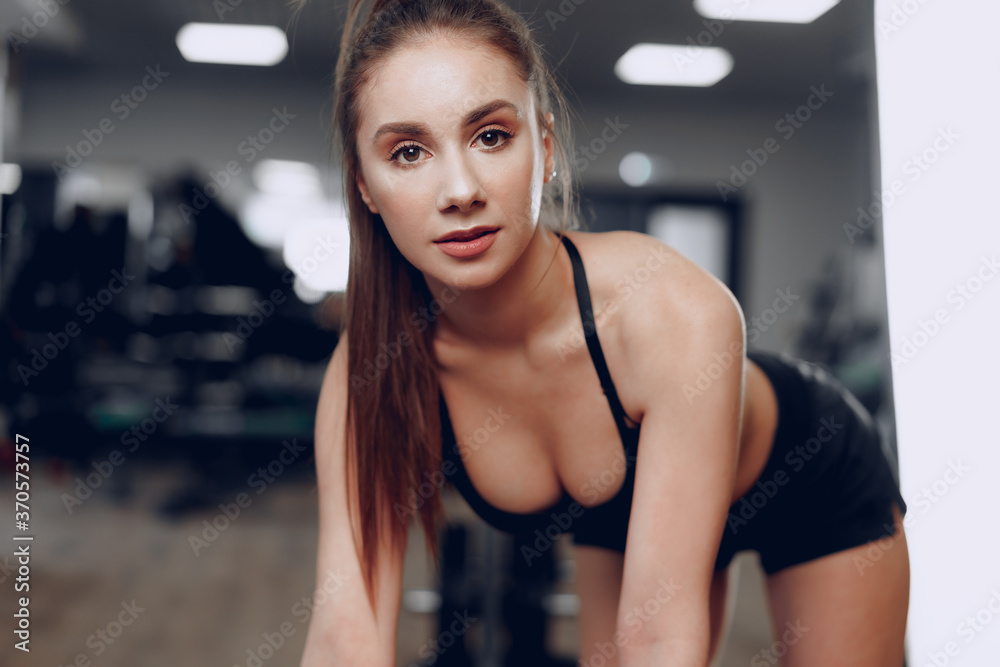 Portrait of a young sporty caucasian woman training in a fitness club