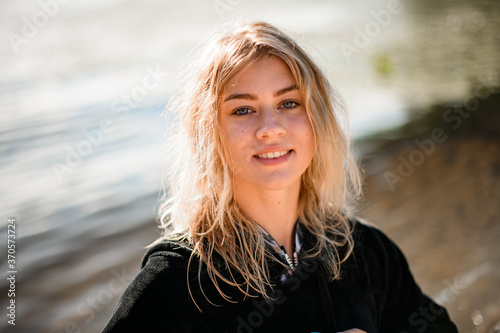 portrait of young beautiful blonde woman in black clothes © fesenko