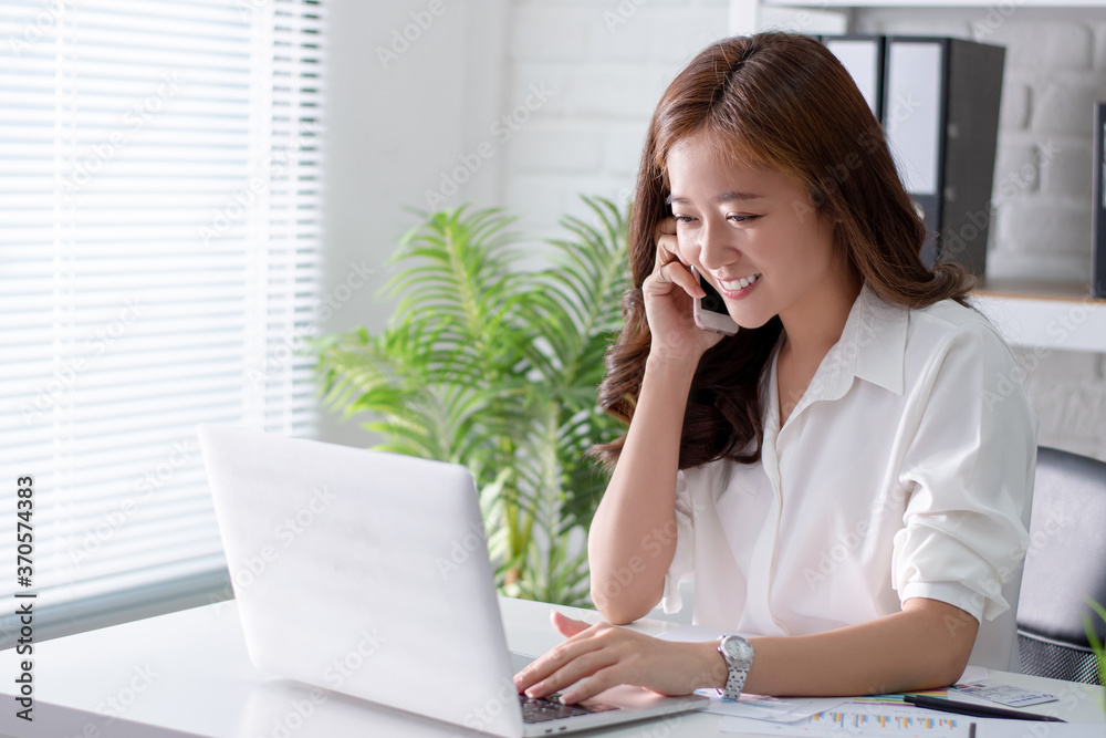 Beautiful Asian businessmen. Online sales are answering customers' questions with laptops at the office. Beautiful Asian businessmen. Online sales are answering customers' questions with laptops at the office.